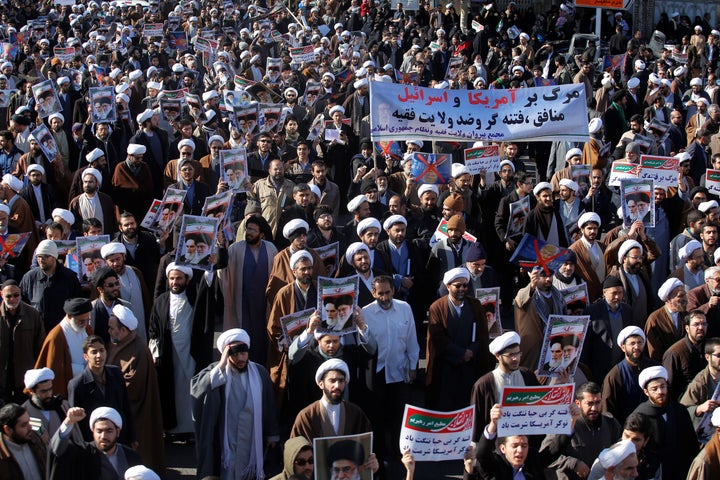 Iranians take part in a state-organized rally against anti-government protests.