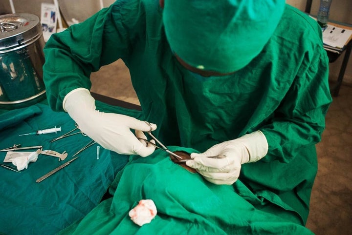 Ewnetu Melesse, an ophthalmic nurse, performs sight-saving eyelid surgery on Bugune, carefully removing the ingrowing eyelashes caused by trachiasis, the advanced form of trachoma.