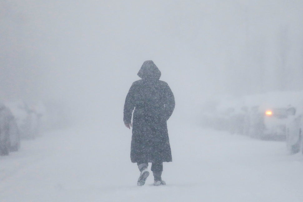 A woman walks down the street during a blizzard in Long Beach, New York. 