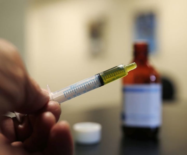 A syringe loaded with a dose of CBD oil is shown in a research laboratory at Colorado State University in Fort Collins, Colo. 