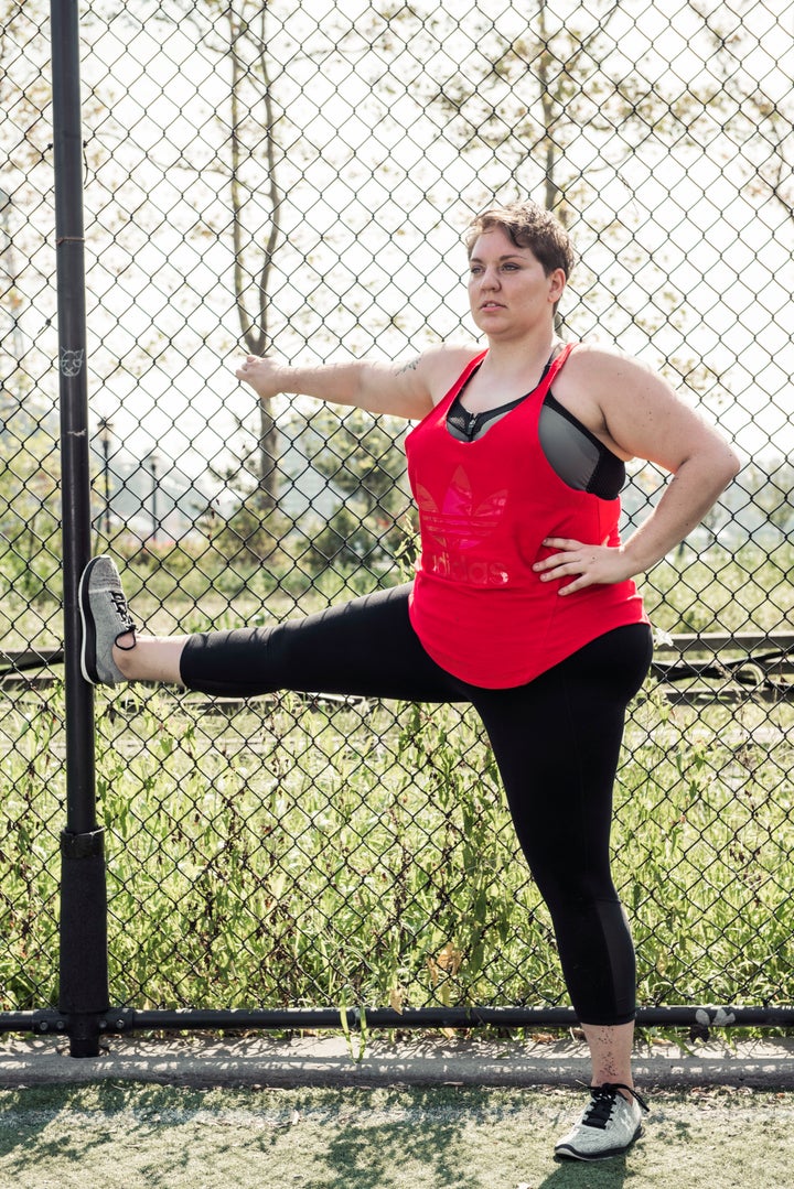 Woman plus size in gym doing exercises with training apparatus, female XXL  losing weight, fat model working with her body in fitness hall, healthy  lifestyle and diet Stock Photo