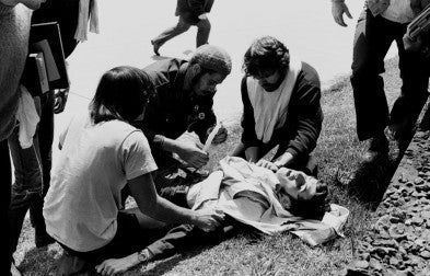 Wounded Kent State student John Cleary grimaces as ill-equipped students fight to save his life, May 4, 1970.