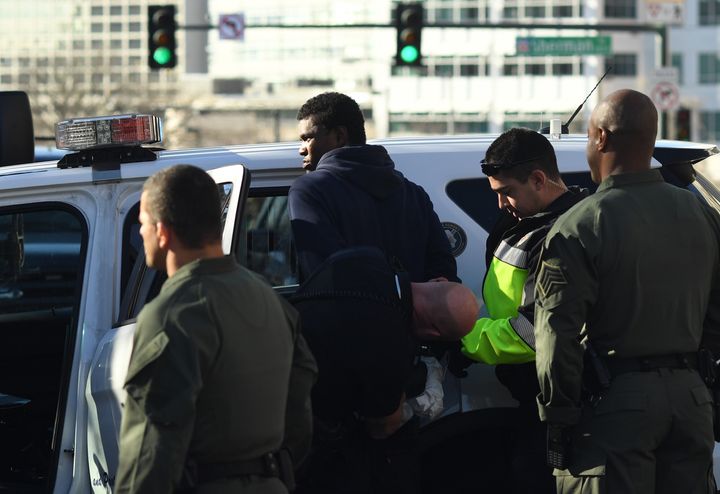 Denver police take a man into custody on the intersection of Sherman Street and Colfax Avenue after reports of shots fired near the state Capitol on Jan. 4, 2018.