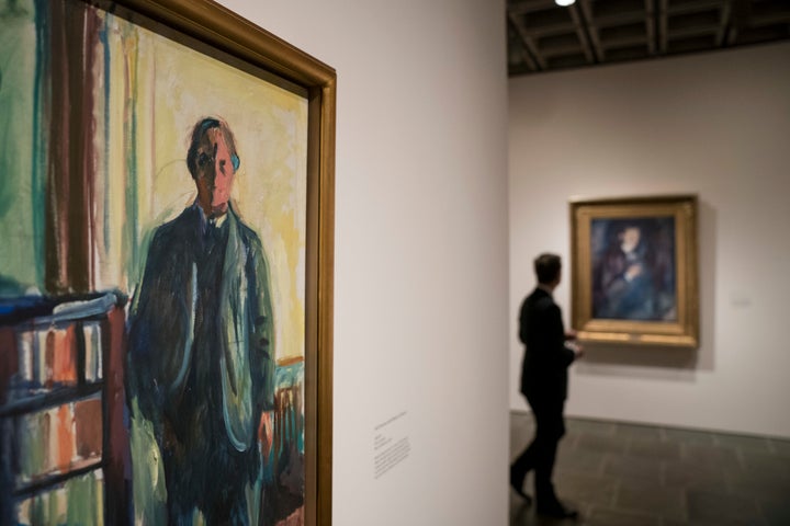 A man pauses in the self-portrait section of the Edward Munch exhibition titled "Between The Clock and The Bed" at the Met Breuer in New York City in November. 