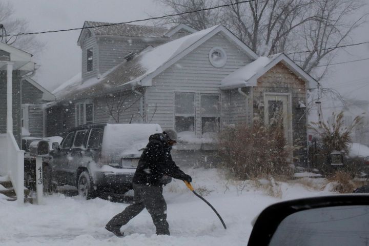 A man shovels snow outside a home in Union Beach, New Jersey, on Jan. 4, 2018.