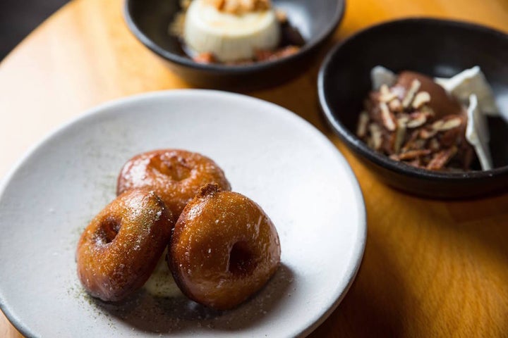 A plate of mini doughnuts, served with a creamy coulis of lovage and lemon verbena, is as sweet as the ambiance. 