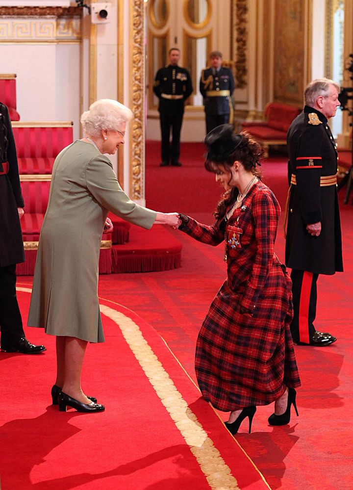 Queen Elizabeth II present Helena Bonham Carter with her CBE medal. 