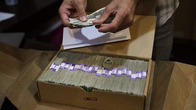 <p>The owner of a medical marijuana dispensary in Los Angeles prepares his monthly tax payment. Marijuana businesses may become even more dependent on cash thanks to recent action from Attorney General Jeff Sessions.</p>