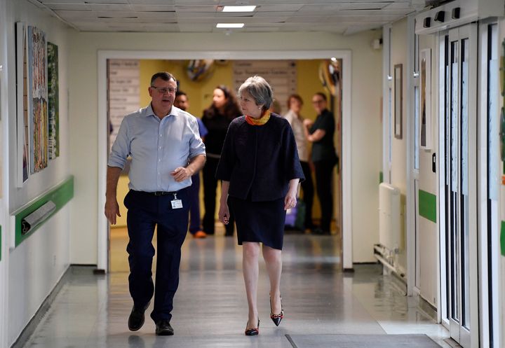 Theresa May has apologised for delays to thousands of NHS operations as a result of winter pressures