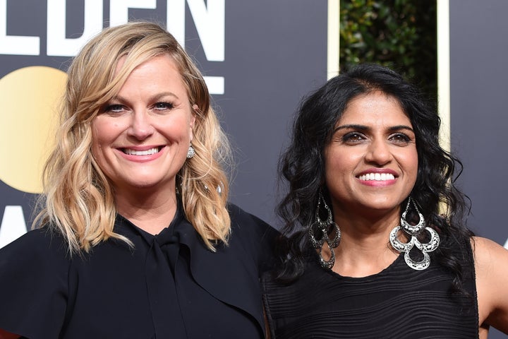 Amy Poehler and activist Saru Jayaraman at the Golden Globes Jan. 7.