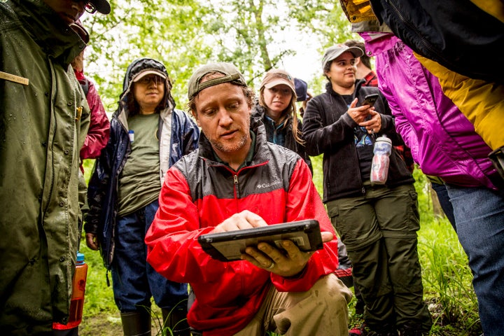 A hydrologist from National Park Services teaches volunteers about the technology used to determine landforms.