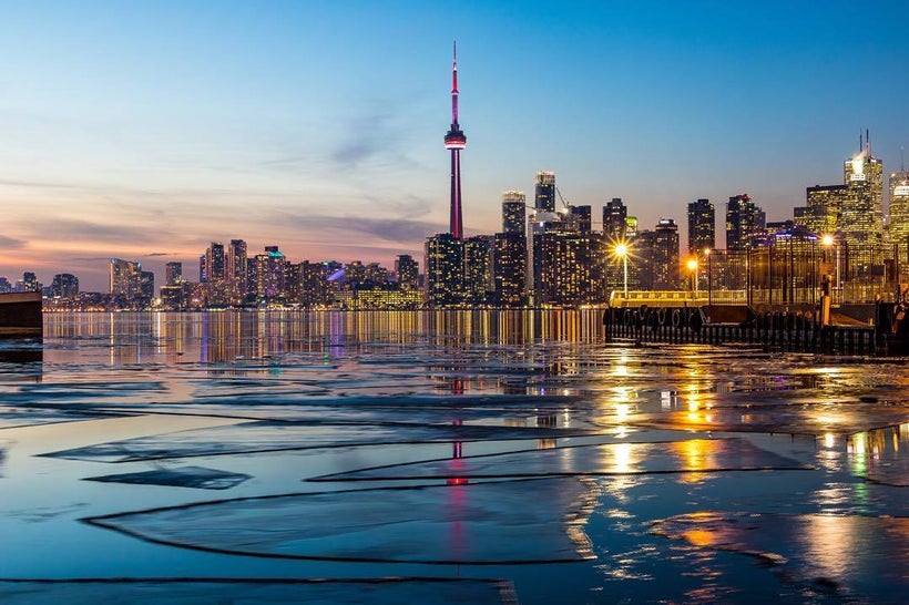 Sun setting behind the Toronto skyline.