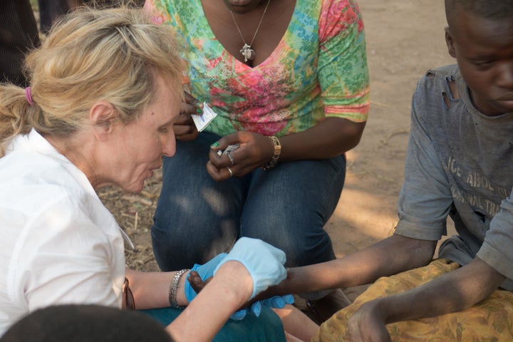 Texas-based neurologist Suzanne Gazda treats a child with nodding syndrome in 2015 in Tumangu in northern Uganda.