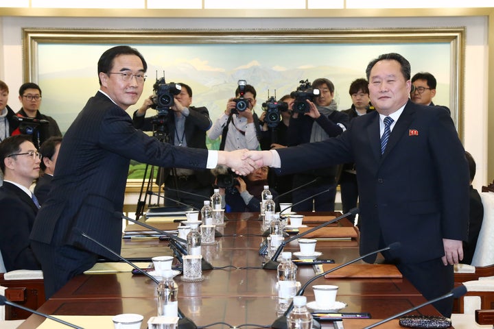 Cho Myoung-gyon, South Korea's unification minister, left, and Ri Son Gwon, chairman of North Koreas Committee for the Peaceful Reunification of the Fatherland, shake hands during a meeting in the village of Panmunjom in the Demilitarized Zone, Jan. 9, 2018.