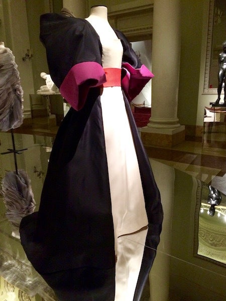 This 1982 ballgown by Roberto Capucci throws caution to the wind by combining fuchsia pink with red, and different textures o