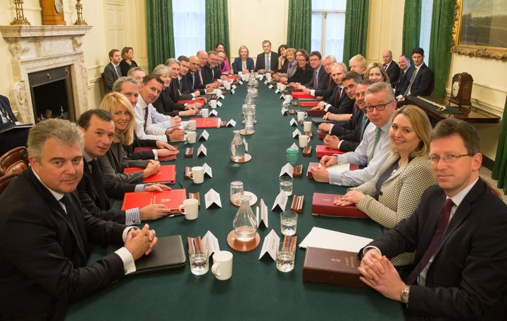 Theresa May poses with her newly constituted cabinet on Tuesday morning.