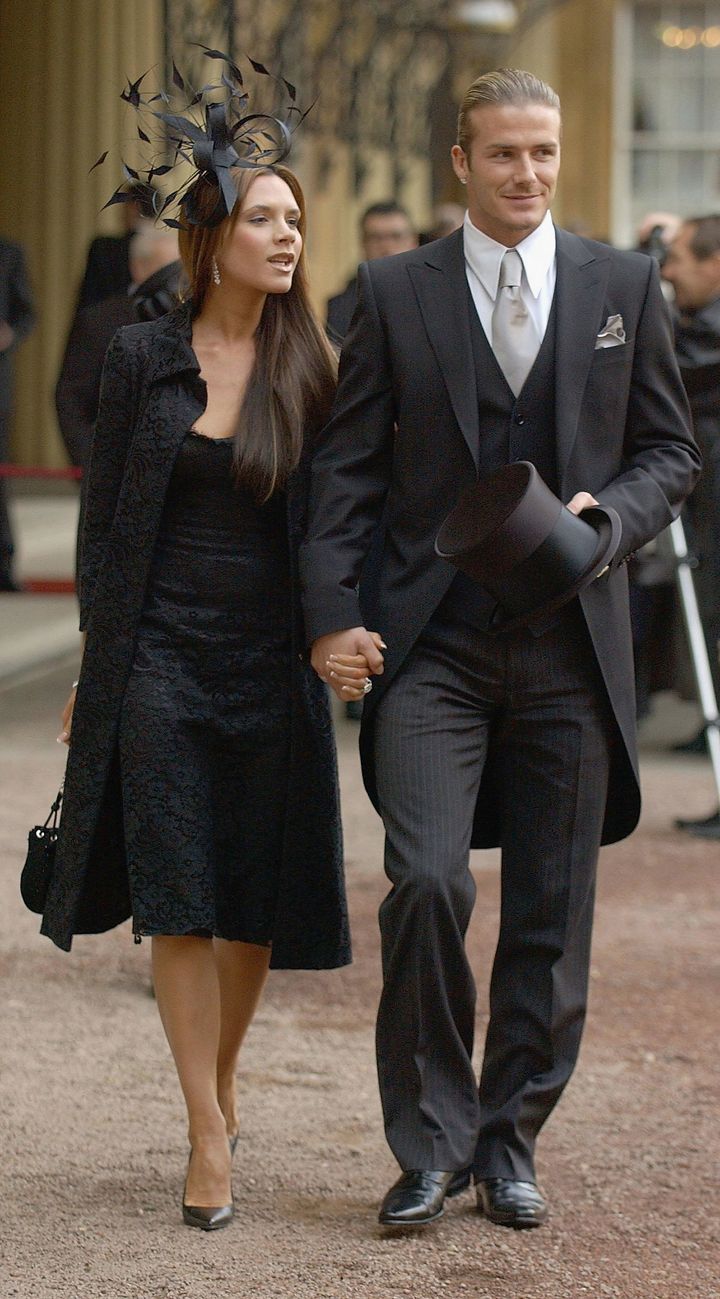 Beckham and wife Victoria attending his OBE ceremony in 2003. 