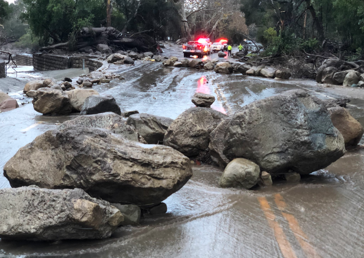 Heavy rainfall over areas scorched by wildfires late last year triggered boulders and mud running into streets.