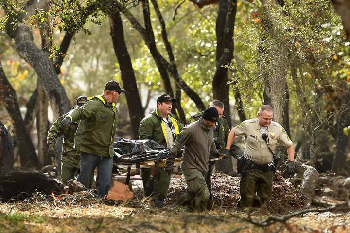 Sheriffs deputies carry a body in Montecito, California; at least 13 people have been killed by mudslides
