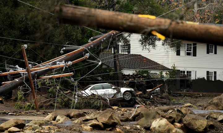 A car sits amongst a pile of rubble in Montecito where mudslides and debris were powerful enough to move boulders 