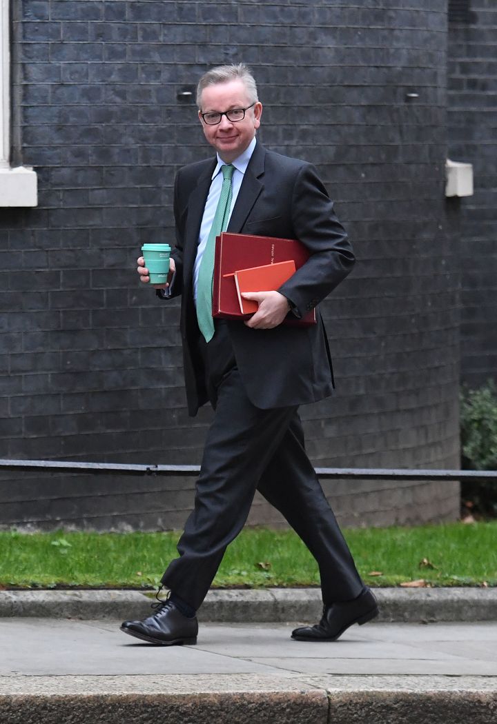 Environment Secretary Michael Gove holds a reusable coffee cup as he arrives in Downing Street for a Cabinet meeting.