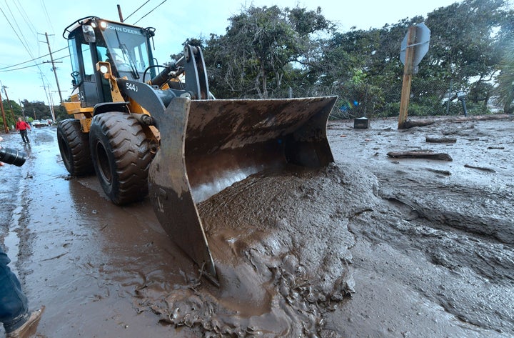 A bulldozer clears mud off the road near a flooded section of U.S. 101 near the San Ysidro exit in Montecito, California, on Tuesday.