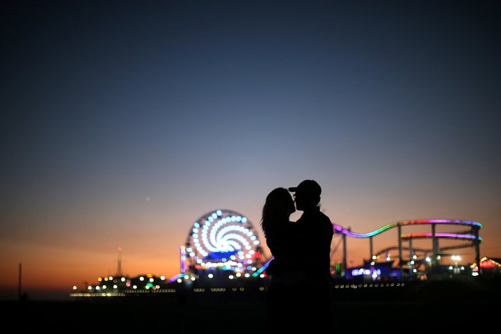 A couple in front of the Santa Monica Pier. Since 2015, the Los Angeles suburb has been attempting to measure the well-being and happiness of its citizens.