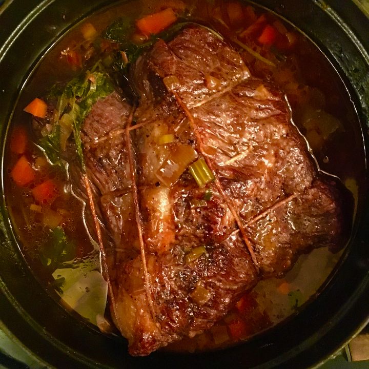 The browned brisket returned to the casserole for braising
