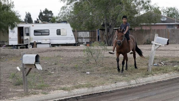 A boy rides a horse through a colonia near Alamo, Texas. The makeshift settlements are among the areas where counting residents is a challenge.