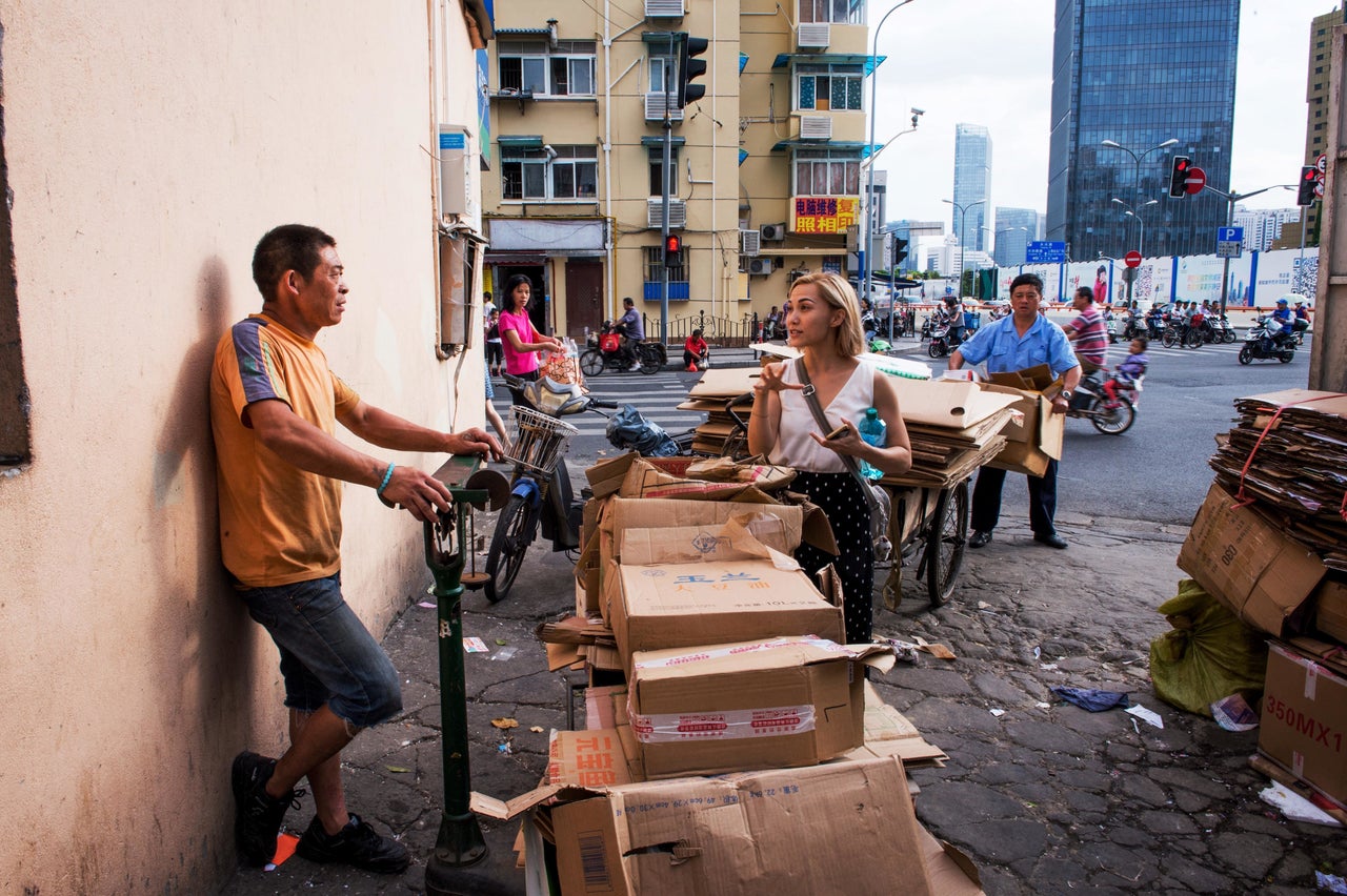 Reporter Dominique Mosbergen, right, speaks to a recycler at an informal sorting center for recyclable waste.