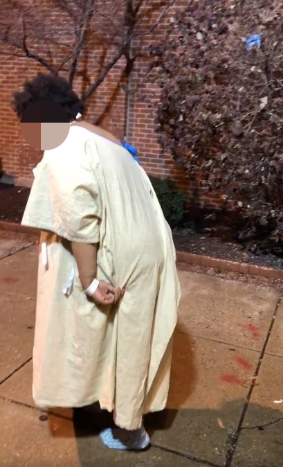 A woman who was filmed wandering around outside of a Maryland hospital wearing only a hospital gown and socks is said to now be with family.