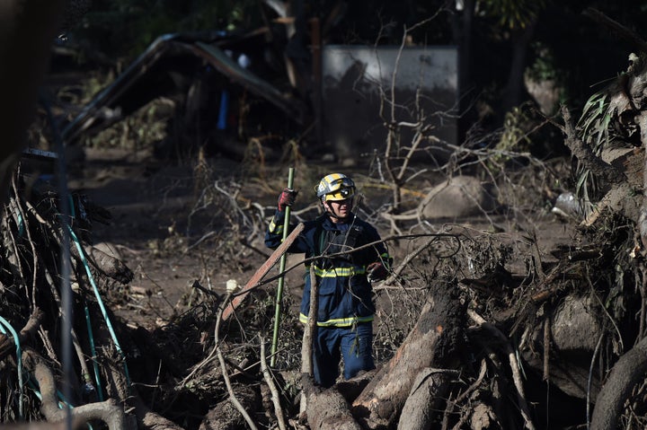 A member of the Orange County Urban Search and Rescue team looks for people missing in the aftermath of a massive mudslide in