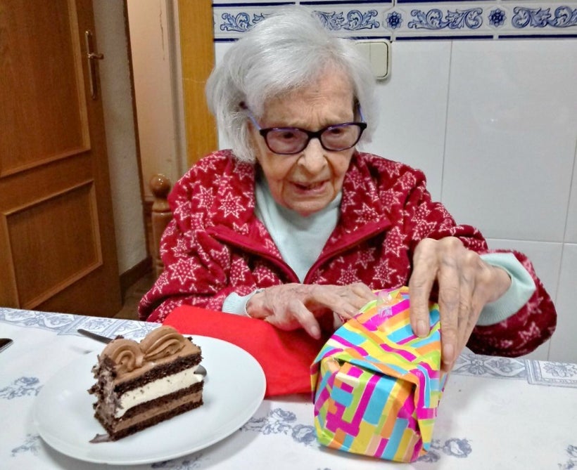 <em>Abuelita opening presents </em>