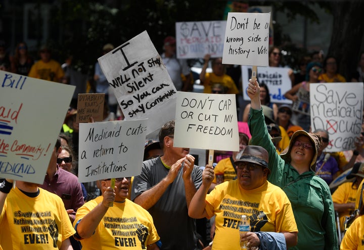 Protesters gather in Denver in July to pressure Colorado's governor to turn down a bill that would limit Medicaid.