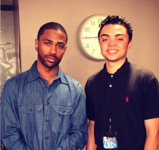 Rhymes with Reason founder Austin Martin (right) posing with rapper Big Sean after presenting at the 2017 internationally acclaimed WE Day conference