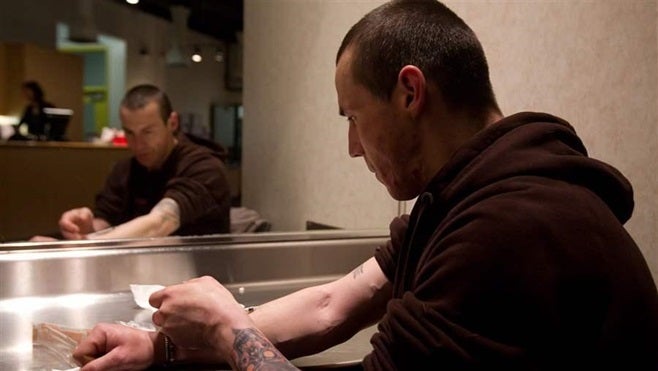 In this file photo, a man injects heroin he bought on the street at the Insite safe injection clinic in Vancouver, Canada. In