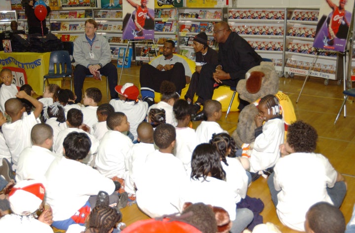 NBA player Lebron James (center) attends a Scholastic Book Fair at Portage Path Elementary School in Akron, Ohio.