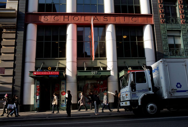 Pedestrians walk past Scholastic headquarters in New York.