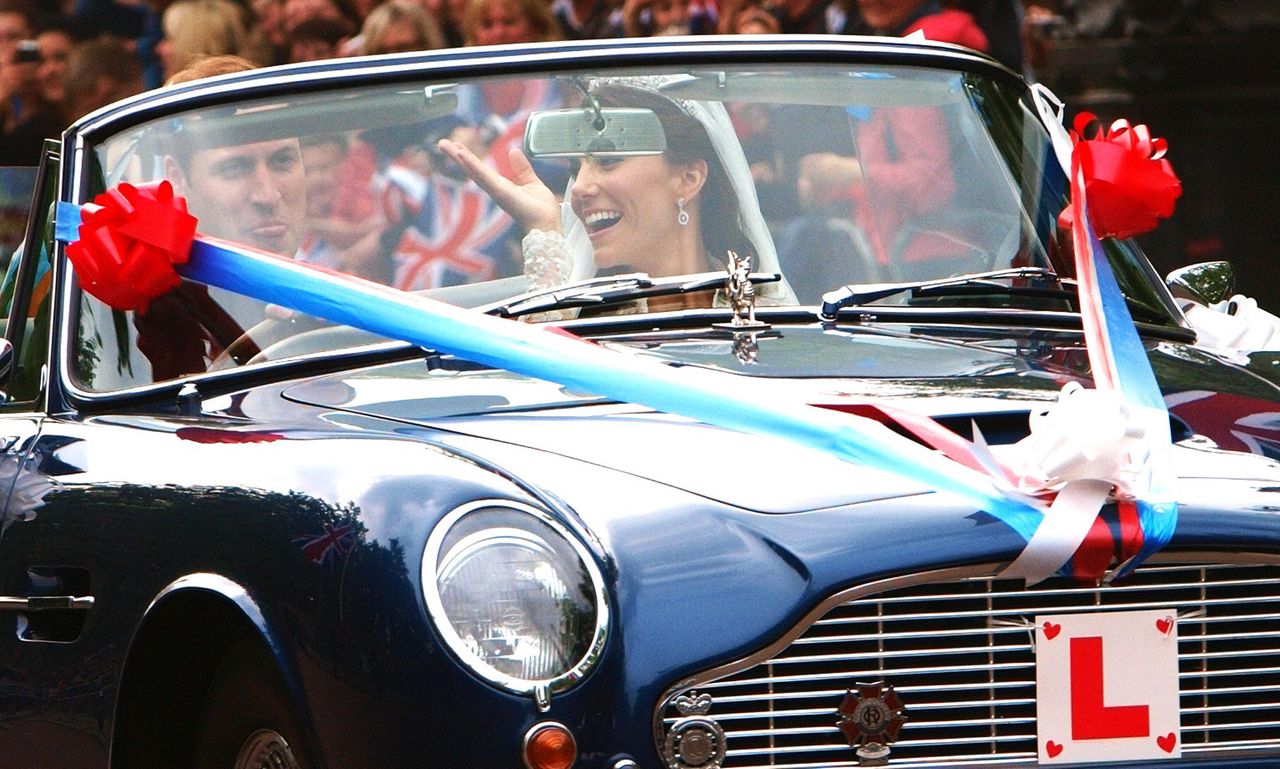 Getty photographer Max Nash snaps Prince William sticking his tongue next to the Duchess of Cambridge, as they drive Prince Charles' Aston Martin, covered in bunting, down the Mall. 'I'm sad I couldn't have taken it,' says Jackson.