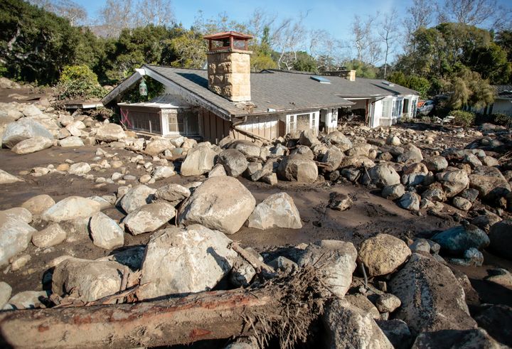 Boulders surround a mud-filled property in Montecito, California on Friday.