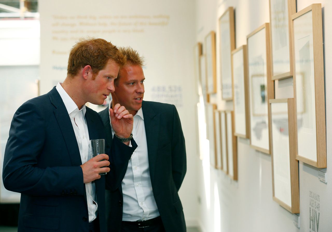 Prince Harry views Jackson's photographs of the Sentebale charity.