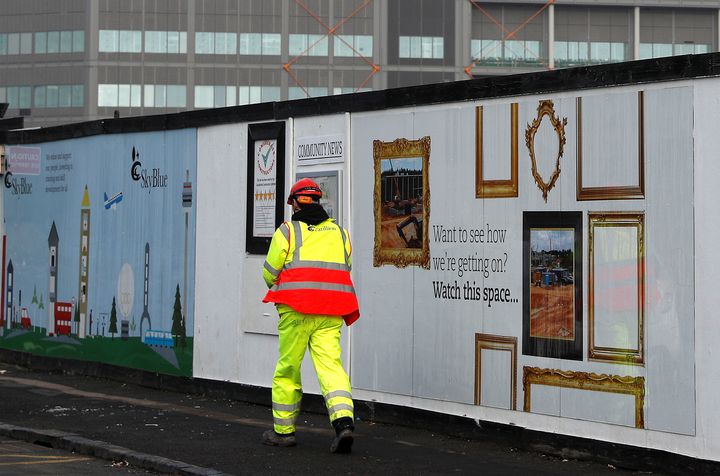 A Carillion worker walks through the firm's Midland Metropolitan Hospital construction site in Smethwick. 20,000 workers are employed by the firm in Britain