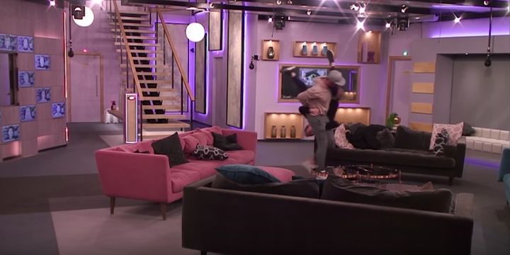 Andrew and Courtney play-fighting by the sofasz