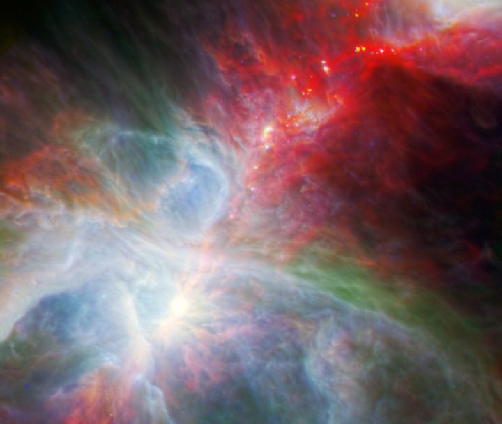 This new view of the Orion Nebula taken by Spitzer highlights the fledgling stars hidden in the gas and clouds.