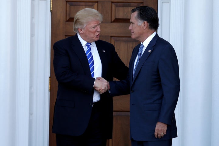 Former Massachusetts Gov. Mitt Romney (R) shakes hands with then President-elect Donald Trump following a meeting in New Jersey in 2016.