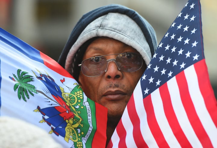 Protestor Pierre Gabriel from Haiti carries flags during a march on Martin Luther King, Jr. Day in Times Square. 