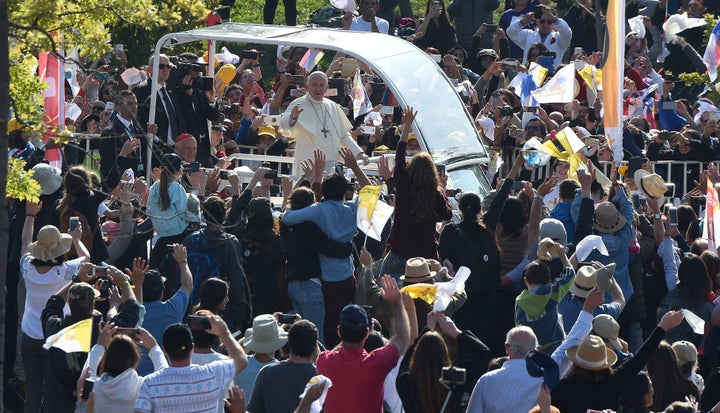 Pope Francis waves at the crowd from the popemobile as he arrives at O'Higgins Park in Santiago on January 16, 2018 to give an open-air mass.