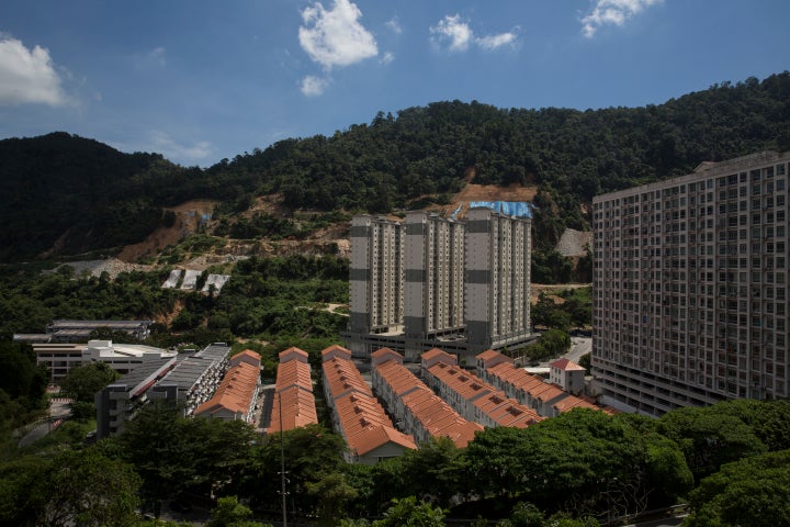 High-density condominiums and houses built on a newly cut hill in Penang.