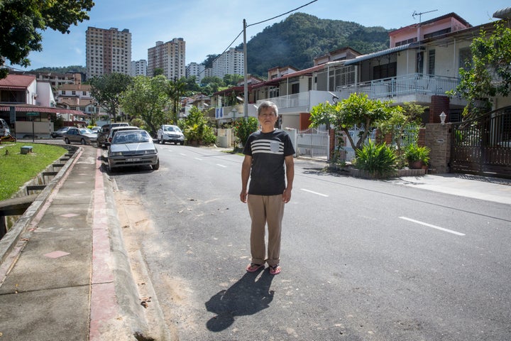 Oo outside his house in Penang.