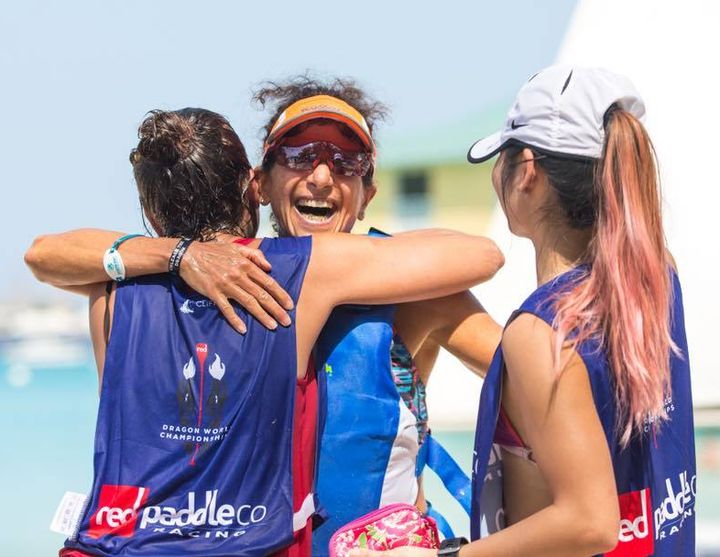Stefani (author) finishing 9K Dragon Run with hugs from Red SUP Ladies.